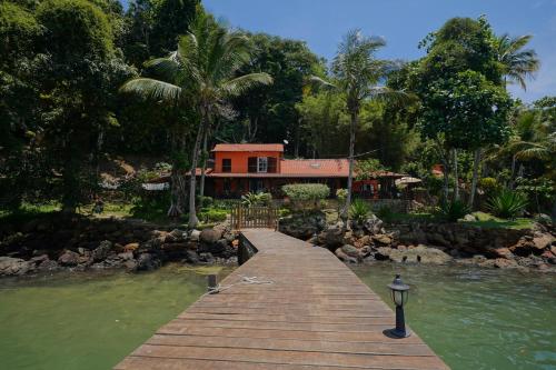 a house on a wooden bridge over a body of water at CASA DA ILHA INN AND SPA Anexo1 in Angra dos Reis