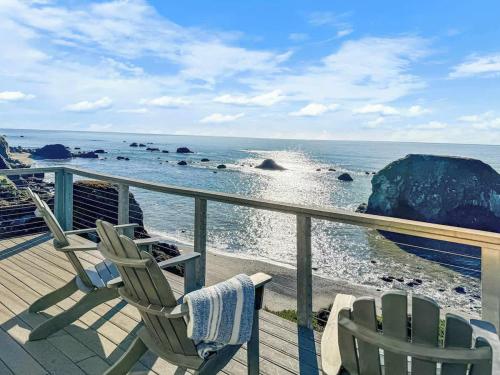two chairs on a deck looking out at the ocean at Seaside Elegance Oceanfront Escape with 3 Suites in Carmet