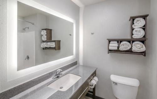 a white bathroom with a sink and a mirror at My Place Hotel-Jonesboro, AR in Jonesboro