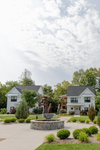 a house with a fountain in front of it at Bay Pointe Inn in Orangeville