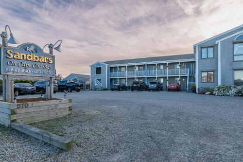 a sign in front of a building with a parking lot at Sandbars Inn - Dog Friendly in North Truro
