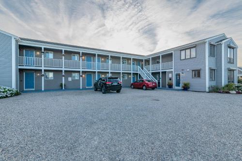 a parking lot in front of a large building at Sandbars Inn - Dog Friendly in North Truro
