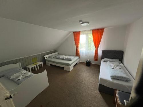 a small room with two beds and a window at Siegen Achenbach 3 in Siegen