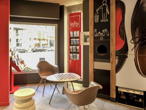 a coffee shop with chairs and a table and a window at ibis Lyon Centre in Lyon
