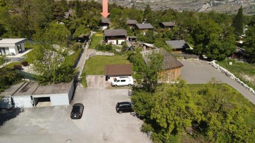 an aerial view of a house with cars parked in a parking lot at Chalet Oase in Susten