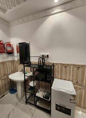 a bathroom with a sink and a tv on a counter at إيوان الفخامة in Medina