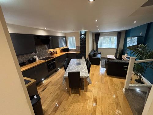 a kitchen and living room with a table and a couch at Balnakeil house