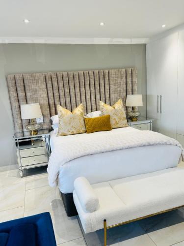 a bedroom with a large bed and two night stands at Luu Luxury Suite in East London