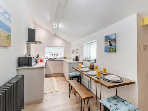a kitchen with a table and a dining room at 2 Bed in Amble 91206 in Amble