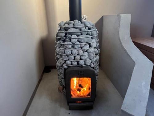 a wood fired oven sitting in a room at Bungalow One - Vacation STAY 49000v in Kawaguchi