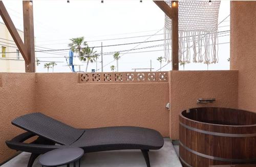 a room with a chair and a bath tub at Bungalow One - Vacation STAY 49000v in Kawaguchi