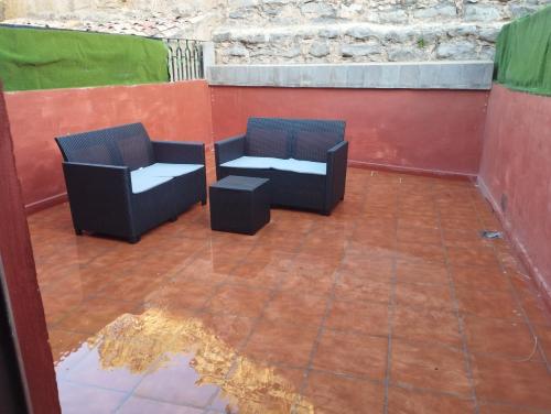 two chairs sitting on top of a patio at Apartamentos calatorao in Calatorao