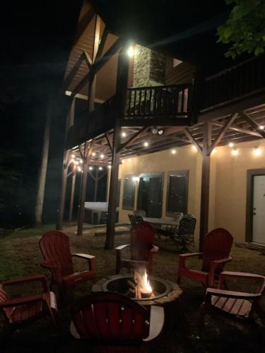a fire pit in front of a house at night at The Feisty Fox in Sugar Mountain
