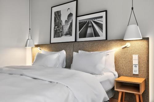 a bedroom with two beds and two pictures on the wall at Radisson Hotel Kaunas in Kaunas