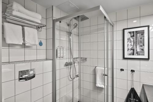 a bathroom with a shower with a glass door at Radisson Hotel Kaunas in Kaunas