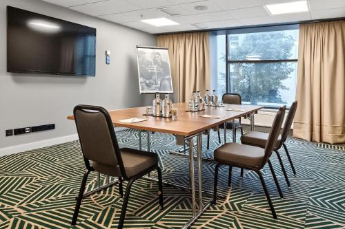a conference room with a wooden table and chairs at Radisson Hotel Kaunas in Kaunas