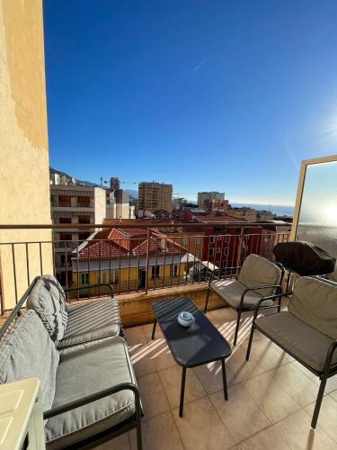 a balcony with a couch and chairs and a table at Super Monaco 2 in Beausoleil