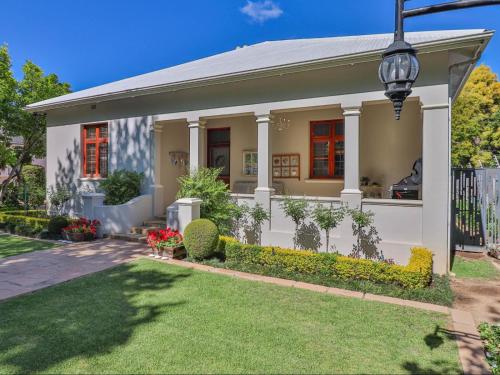 a white house with a gate and a yard at 15 On Le Roux in Robertson