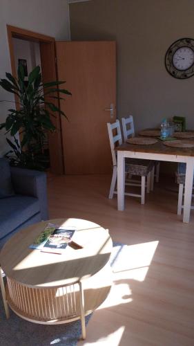 a living room with a table and a table and chairs at Beas Ferienglück in Busenberg