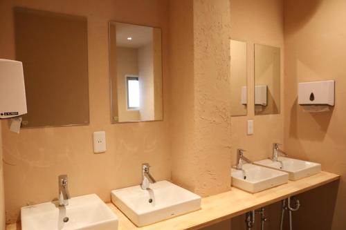 a bathroom with three sinks and two mirrors at 2-times,Dormitory Hotel - Vacation STAY 43019v in Itoshima