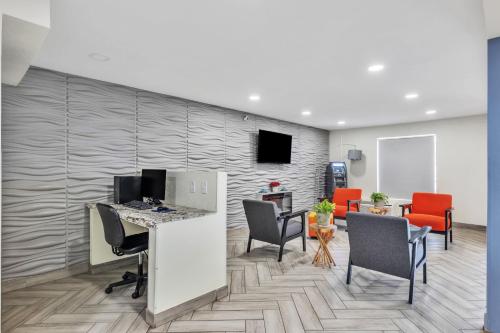 an office with a desk and chairs and a wall at Super 8 by Wyndham Morganton in Morganton