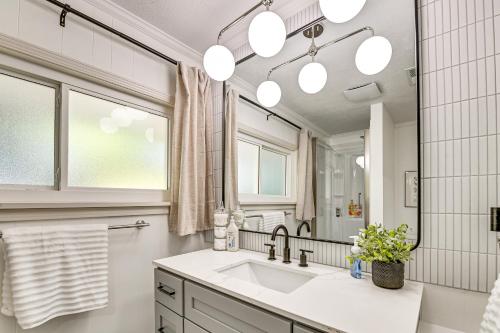 a bathroom with a sink and a large mirror at Herrington Lake Retreat with Dock, 1 Mi to Marina! in Bushtown