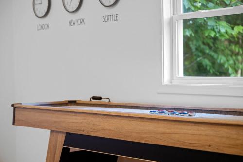 a wooden table with clocks on a window at Vista View in Sugar Grove