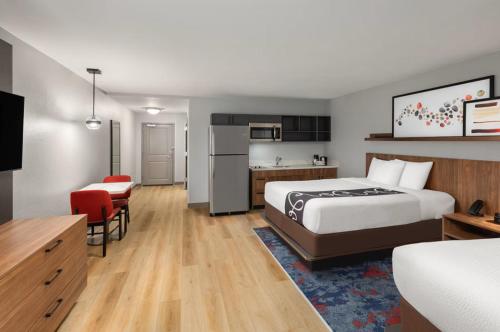 a hotel room with a bed and a kitchen at Hawthorn Extended Stay by Wyndham Knoxville in Knoxville