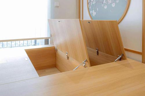 a room with two wooden cabinets and a mirror at Fuji Room Ở Space Ecopark in Kim Quan