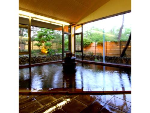 a large room with a rain soaked floor and windows at Yahatakan - Vacation STAY 32426v in Sado
