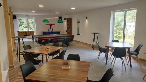 a dining room with tables and a pool table at Amálkin Dvor in Podbrezová
