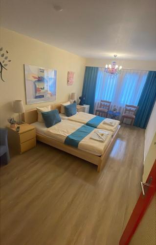 a bedroom with a large bed with blue pillows at Zak Neuhausen in Neuhausen am Rheinfall