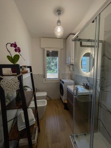 a bathroom with a shower and a toilet and a sink at Apartment-alys in Pordenone