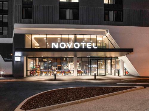 a nootir store in front of a building at night at Novotel Devonport in Devonport