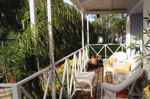 a porch with chairs and plants on a house at Posada Suiza by Prima Collection in San Miguel del Monte