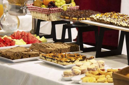 a table topped with different types of food on plates at Posada Suiza by Prima Collection in San Miguel del Monte