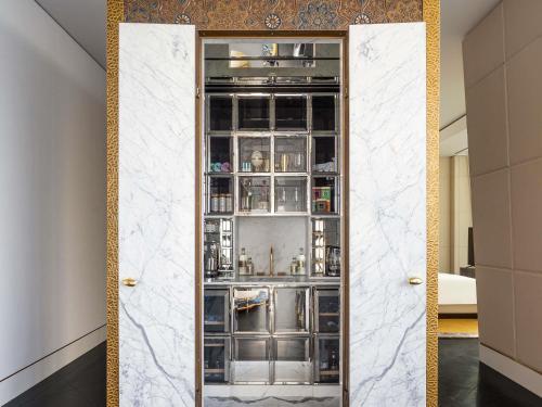 a door leading into a kitchen with a bar at Raffles Doha in Doha