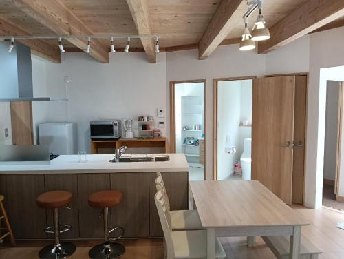 a kitchen with a table and a kitchen with wooden ceilings at Star Dome - Vacation STAY 20283 in Shimoda