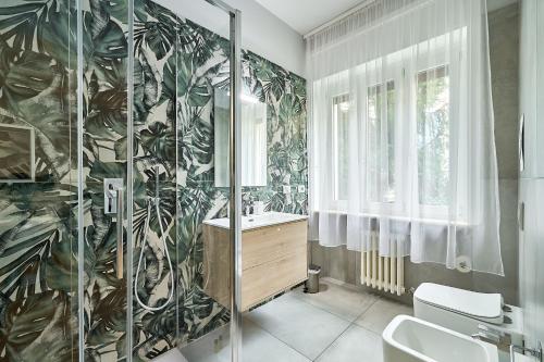 a bathroom with a shower and a toilet and a sink at Leila's home forever - casa vacanze in Bergamo