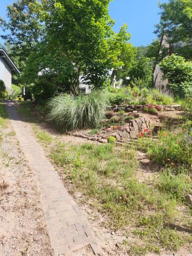 a garden with a brick path and grass at Beas Ferienglück in Busenberg