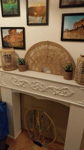 a white console table with baskets and a fan at Beas Ferienglück in Busenberg