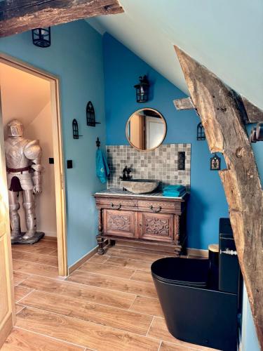 a bathroom with a sink and a mirror at maison climatisée à thème médiéval avec baignoire balnéothérapie in Sens