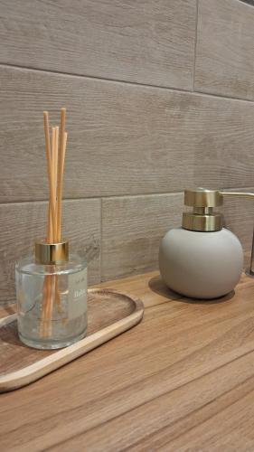 a table with twoented candles and bamboo sticks on it at Il Nocciolo in Gaiola
