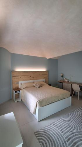 a bedroom with a large bed and a desk at Il Nocciolo in Gaiola