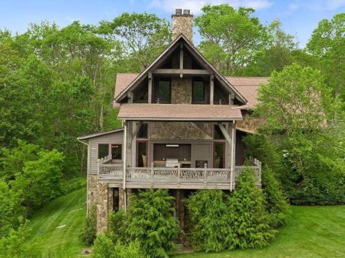 a home with a wrap around porch and a wrap around deck at Overlook at Wilderness Trail in Newland