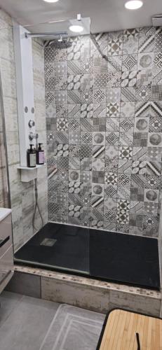 a bathroom with a shower with a glass wall at Appartement Le Saint Julien centre historique in Chartres