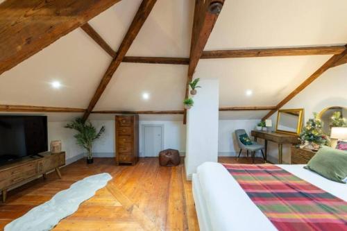 a large room with a bed and a tv at Tranquil Appleby Retreat for 6 Guests with Hot Tub in Appleby