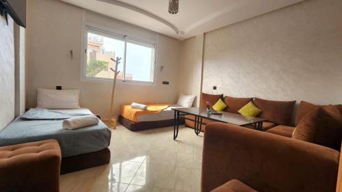 a living room with a bed and a couch at House Viola in Imsouane