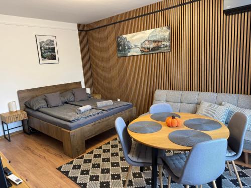 a living room with a table and a bed and a couch at Mini Premium in Miskolc