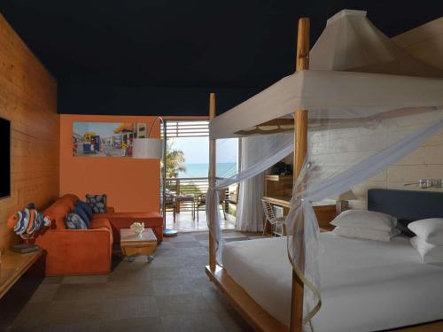 une chambre avec un lit superposé et un salon dans l'établissement Movenpick Resort Lamantin Saly, à Saly Portudal